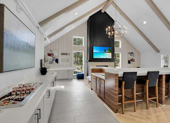 a kitchen with a large island and a table with chairs at AVIA Lofts on Liberty Ridge, Florida