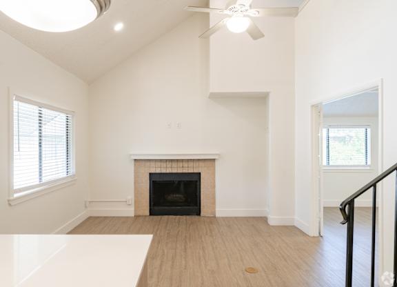 Living room with a fireplace and a ceiling fan at Avia Lofts at Maple Road, Amherst, NY, 14221
