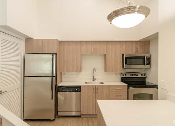 Apartment kitchen with stainless steel appliances at Avia Lofts at Maple Road, Amherst, 14221