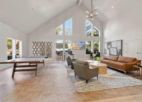 a living room with a couch table and a pool table at AVIA Lofts on Parkway Apartments, Vancouver, 98662