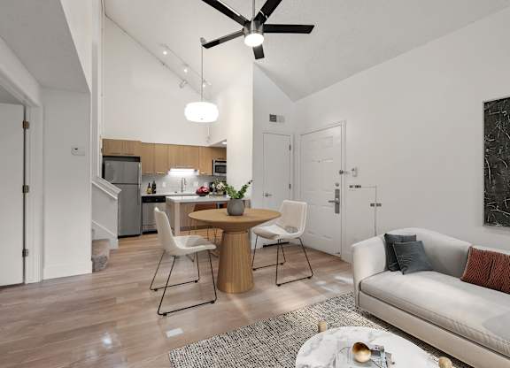 an open living room and kitchen with a table and chairs at AVIA Lofts on Parkway Apartments, Vancouver, WA