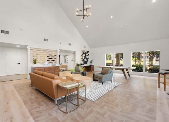 A living room with a couch, chairs, and a coffee table.