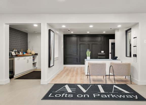 A black and white foyer with a rug that says