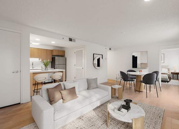 A modern living room with a white couch and a round table at AVIA Lofts on Parkway Apartments, Washington, 98662