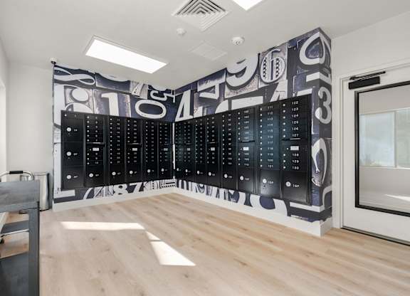 a large wall in a room with a filing cabinet and a desk at AVIA Lofts on Parkway Apartments, Washington