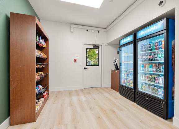 a room with two refrigerators and a counter with a door at AVIA Lofts on Parkway Apartments, Vancouver