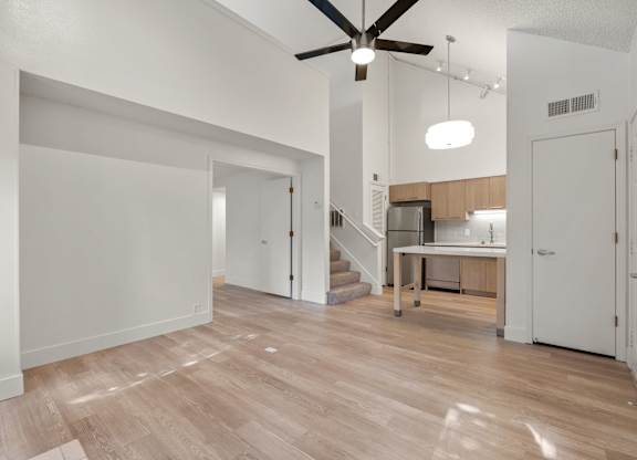 an open living room and kitchen with a ceiling fan at AVIA Lofts on Parkway Apartments, Vancouver, 98662