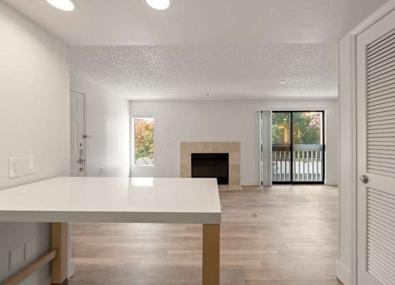 the living room and dining room of a house with a fireplace at AVIA Lofts on Parkway Apartments, Vancouver