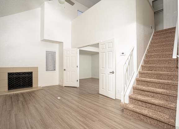 Grey carpeted staircase and a fireplace at AVIA Lofts on Victors Way, Ann Arbor, MI, 48108