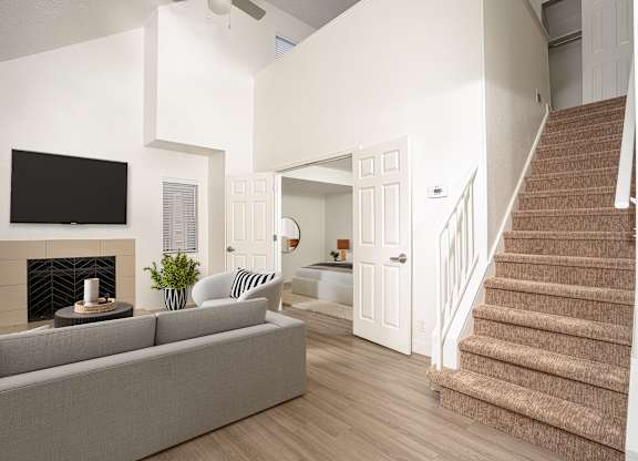 Stunning living room with a staircase at AVIA Lofts on Victors Way, Ann Arbor