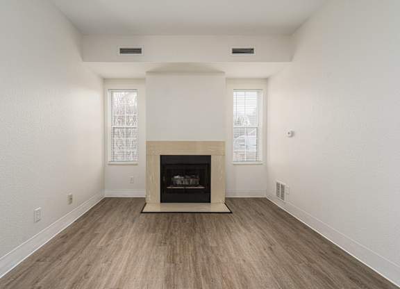 Living room with a fireplace and wooden floors at AVIA Lofts on Victors Way, Ann Arbor, Michigan