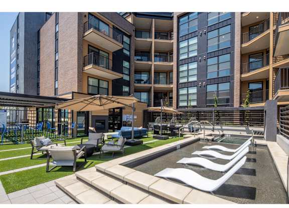 A modern building with a pool in front.