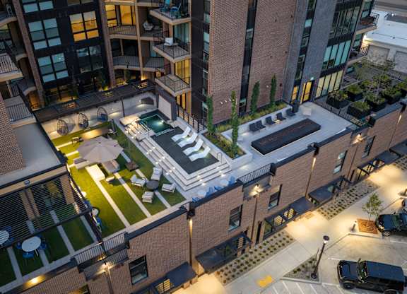 A modern building with a courtyard and a pool.