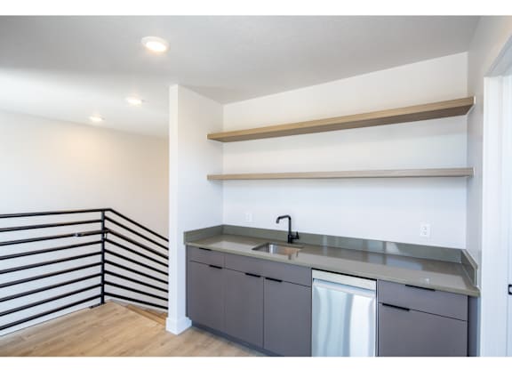 A kitchen with a sink and a dishwasher.