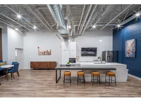A modern kitchen with a dining table and chairs.