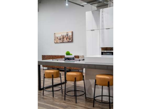 A kitchen with a bar counter and two stools.