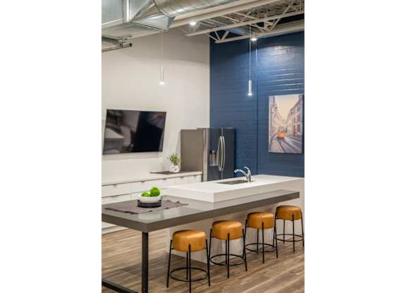 A kitchen with a table and chairs.