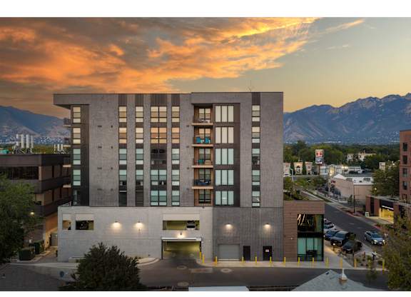 A modern building with a parking garage in front of it.