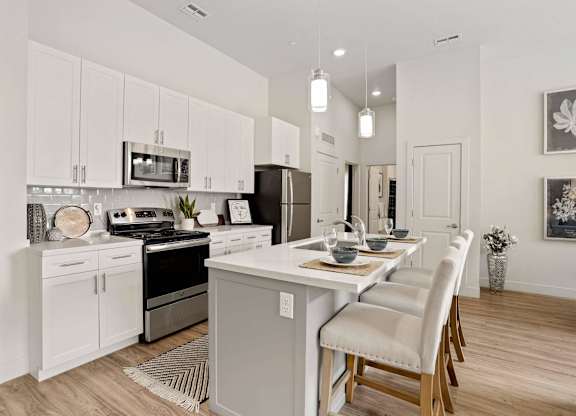 an open kitchen and dining area with a table and chairs at 200 City View, Provo, UT, 84601