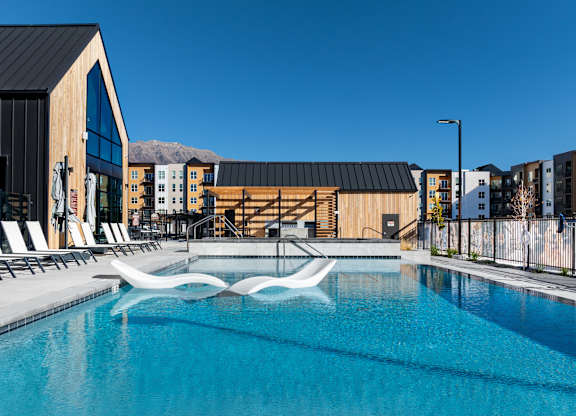 Swimming Pool with chairs at Solhavn Apartments, American Fork
