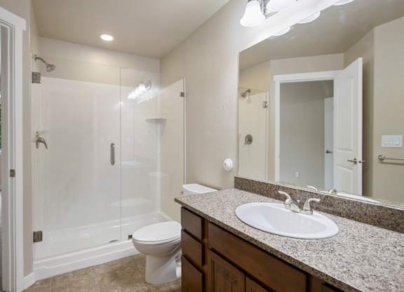 A bathroom with a toilet, sink, and shower at Siena Villas Apartments, Orem, 84097
