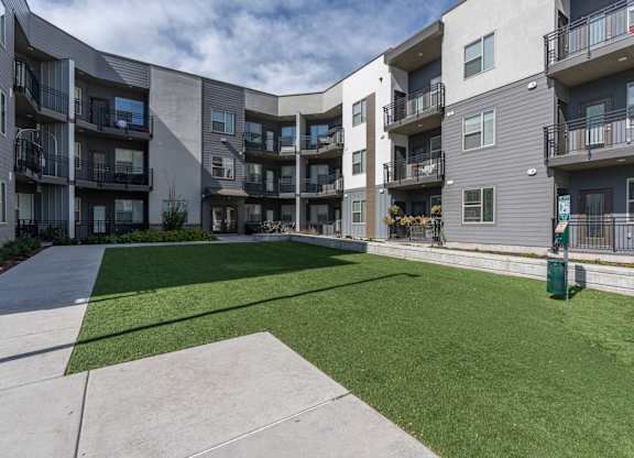 apartments patio and grass at The Flats at Riverwoods, Provo