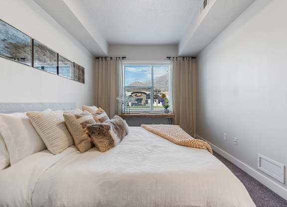 bedroom with a window at The Flats at Riverwoods, Provo, UT
