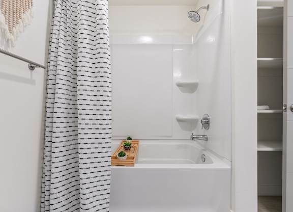 a bathroom with a bath tub and a shower curtain at Paperbox Lofts, Salt Lake City, 84101