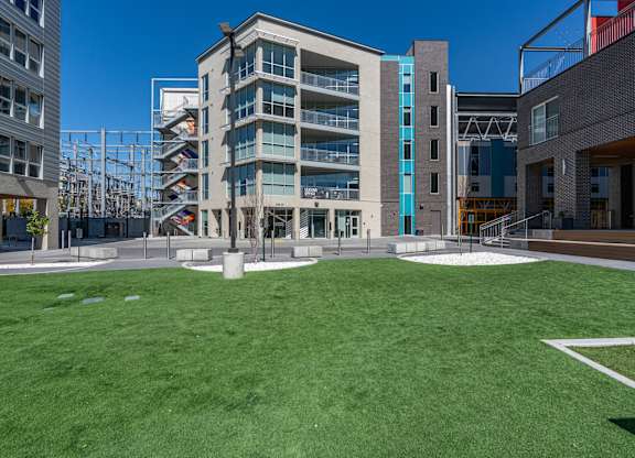 A modern building with a green lawn in front.