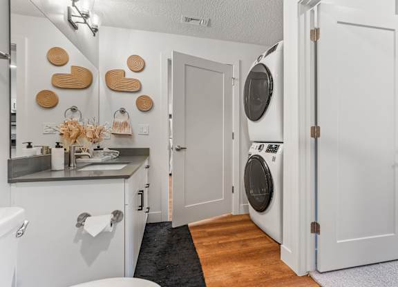 a small laundry room with a washer and dryer and a sink at The Revival, Utah, 84101