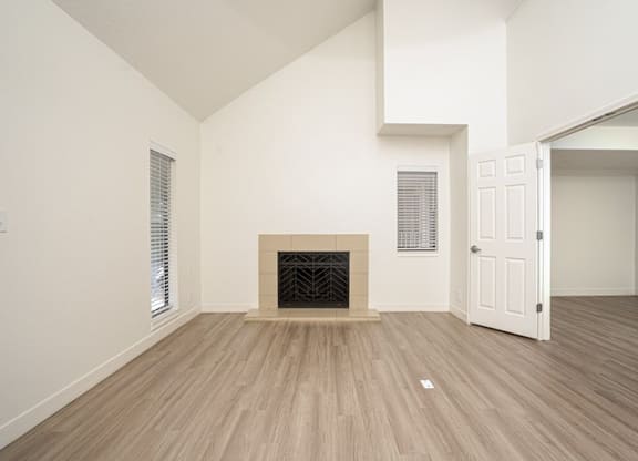 Vacant room with fireplace and wooden floor at AVIA Lofts on Liberty Ridge, Florida