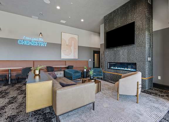 a living room with couches and chairs and a fireplace at SevenO2 Main Apartments, Salt Lake City