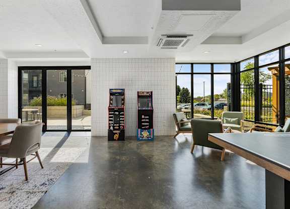 a lounge area with chairs and tables and vending machines at The Flats at Riverwoods, Provo, 84604