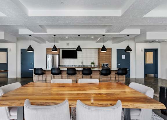a large dining room with a large table and chairs at The Flats at Riverwoods, Provo, Utah