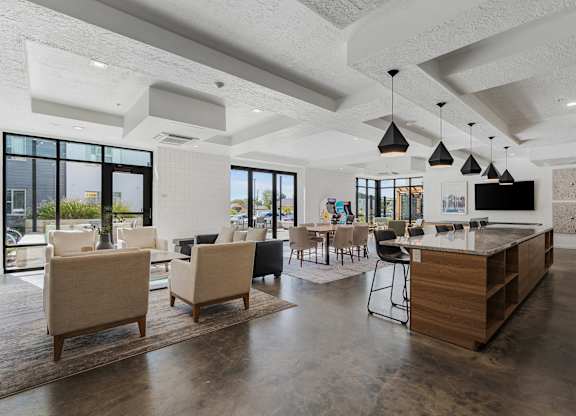 a clubhouse with a bar and chairs and a living room with a television at The Flats at Riverwoods, Provo