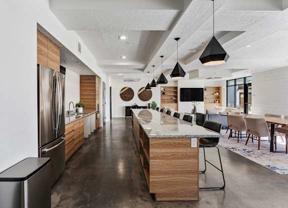 a large kitchen with a large island and a dining room at The Flats at Riverwoods, Provo, UT, 84604