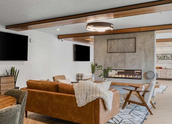 a living room with a fireplace at The Flats at Riverwoods, Provo, Utah