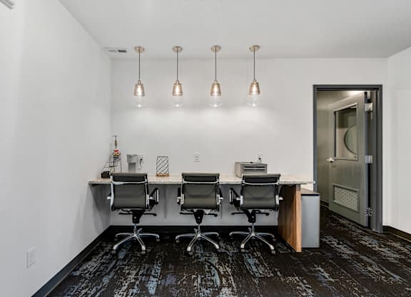a conference room with a desk and chairs and a door at The Flats at Riverwoods, Provo, UT, 84604