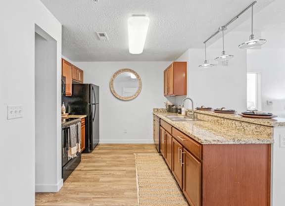 a spacious kitchen with granite counter tops and wooden cabinetsat The View on 20th, Ogden, UT, 84401