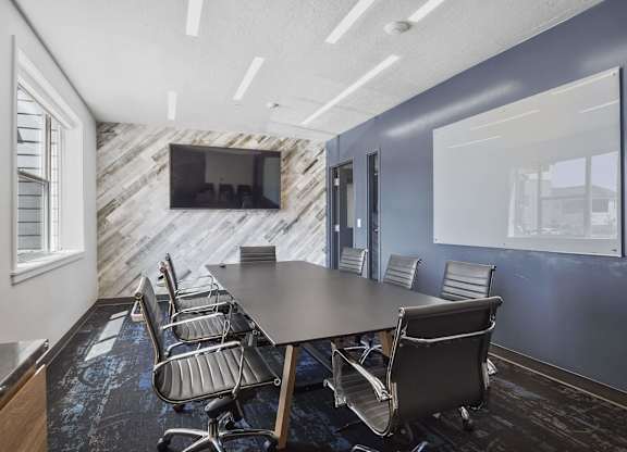 a conference room with a large table and chairs at The Flats at Riverwoods, Provo, 84604
