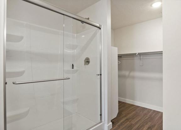 a bathroom with a glass shower stall in a 555 waverly unit at The Flats at Riverwoods, Provo, UT