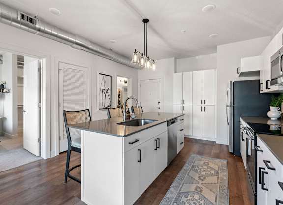 an open kitchen and dining area with a large counter top at The Revival, Salt Lake City Utah
