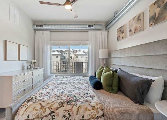 a bedroom with a large bed and a window at The Revival, Utah, 84101