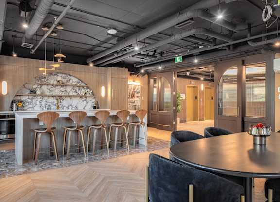 A modern dining area with a round table and chairs.