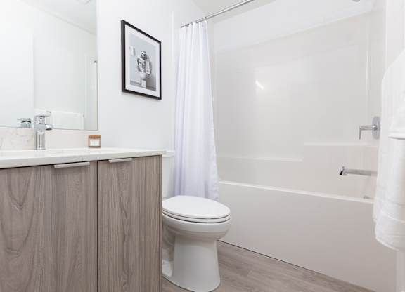A white toilet sits next to a sink in a bathroom.
