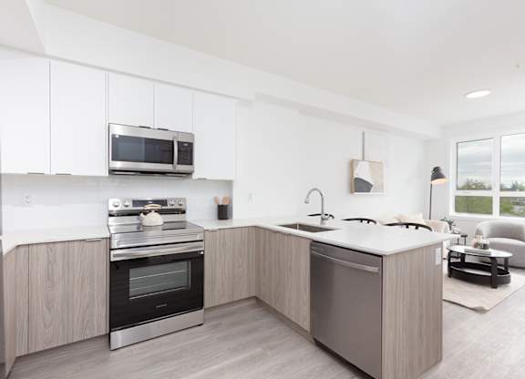 A modern kitchen with a stainless steel oven and microwave.