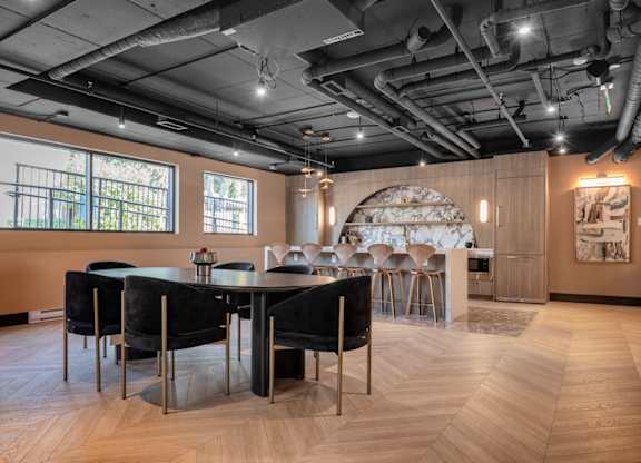 A modern dining room with a large table and chairs.