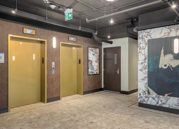 A hallway with three doors and a painting on the wall.