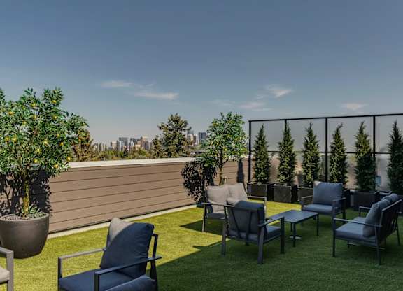 A patio with chairs and a table with a view of the city.