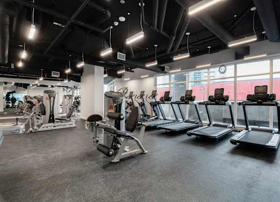 A gym with treadmills and other exercise equipment.